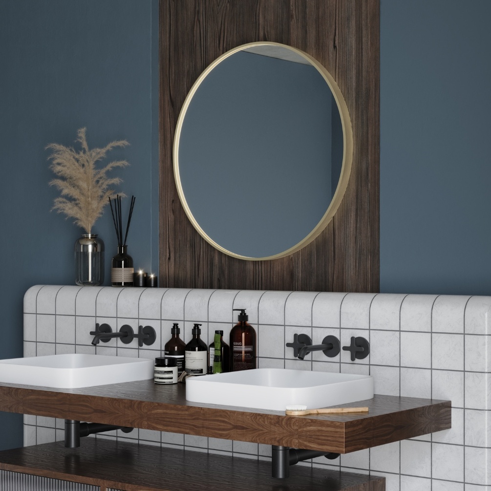 Product Lifestyle image of Origins Living Lomax 700mm x 700mm Brushed Brass Round Mirror mounted on a traditionally inspired bathroom wall above a dual basin setup LMX-00D070-BB
